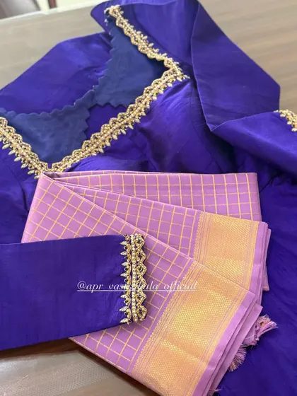 A purple blouse with a simple embroidered border.