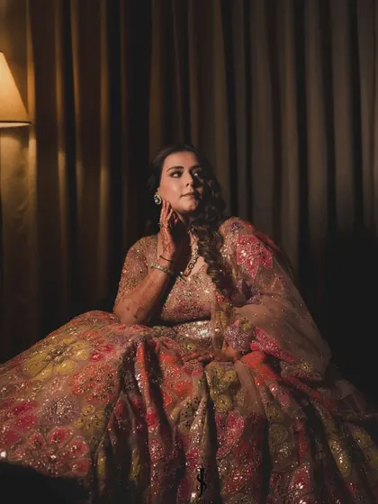A dramatic portrait of the bride in her Sangeet lehenga. The intricate floral embroidery and glittering details are perfect for an evening of dance and celebration.
