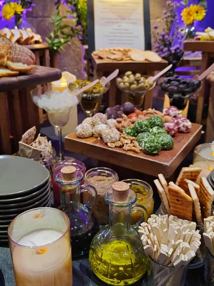 A close-up of the tapas grazing experience for Mercedes, showcasing our selection of olives, cheese balls, nuts, and artisanal breads. We use high-quality ingredients to create a truly indulgent spread.