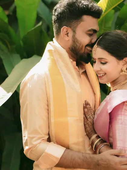 A happy and intimate moment between a South Indian couple, captured in the warm glow of the sun.