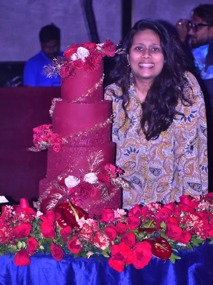 A proud moment standing next to one of my largest creations, a magnificent, multi-tiered red wedding cake, all set up and ready for the celebration.