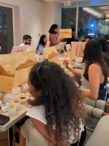 A coffee painting workshop in session. The whole room is filled with the scent of coffee and the quiet hum of creativity.