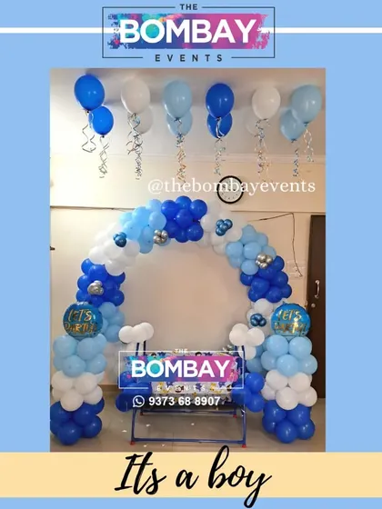 It's a boy! A simple yet charming naming ceremony setup with a blue and white balloon arch, perfect for a cozy home function.