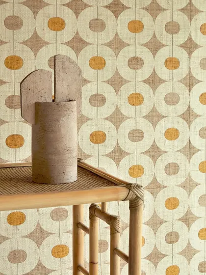 A close-up of the geometric raffia wallpaper, paired with a bamboo console and sculptural vase. This vignette highlights the interplay of natural fibers and sharp architectural lines.