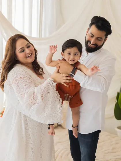 A playful family moment. The joy and laughter in this photo are infectious, showing a family that is completely comfortable and happy in front of the camera.