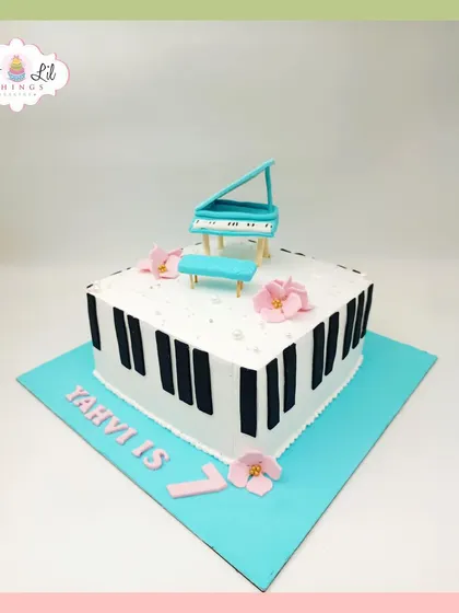 A sweet and simple piano-themed cake for Yahvi's 7th birthday, topped with a miniature grand piano.