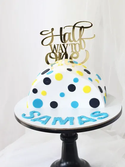 A cute and colorful cake to celebrate being "Halfway to One." This dome-shaped piñata cake is decorated with fun polka dots, perfect for a six-month birthday milestone.