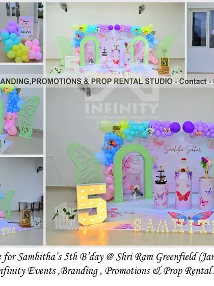 A grand butterfly theme for a 5th birthday at Shri Ram Greenfield. This large setup includes a 3D backdrop with arches and butterfly wings, a colorful pastel balloon garland, and a light-up number "5," creating a stunning visual impact.
