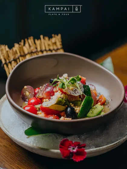 A colourful and fresh salad from Kampai, served over ice with edible flowers. This image represents the artistic presentation and delicate flavours of my Japanese fine dining options.