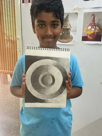 This student mastered the challenge of drawing 3D spheres with just pencil shading, showing a great understanding of light and shadow.