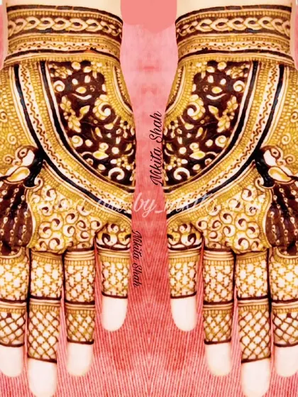A rich and intricate Indian henna design. The use of negative space around the peacocks makes them the central focus.