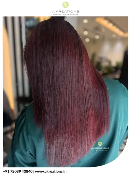 A glossy, fiery, and flawless red transformation. This look was achieved with our expert color application and a nourishing treatment for ultimate shine.