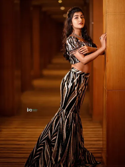 This pose highlights the mermaid-style cut of the skirt and the intricate pattern. It’s a very contemporary and stylish way to wear and photograph a lehenga.