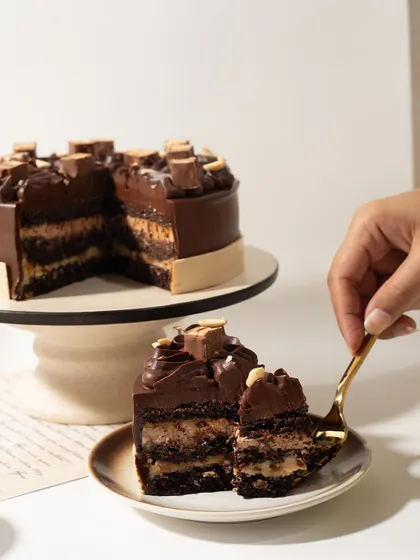 The perfect forkful of our Snickers Cake, capturing all the delicious layers in one go.