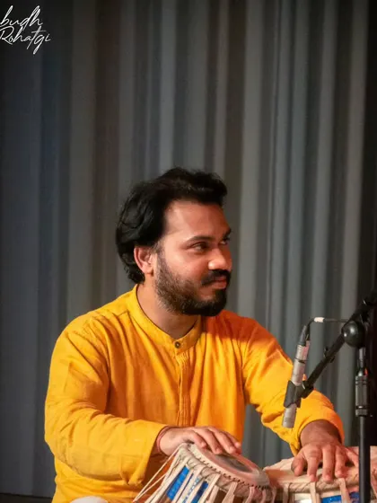 A gallery of cherished moments accompanying the legendary vocalist, Guruji Padma Bhushan Pandit Ajoy Chakraborty ji, at various prestigious festivals.