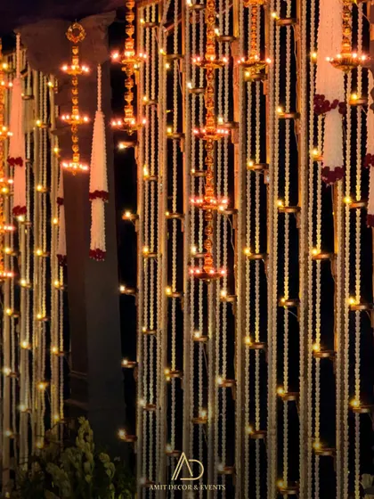A nighttime shot of the hanging diya panels, where the lights create a magical, sparkling effect against the dark background.