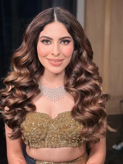 The client looking confident and glamorous with her voluminous curls for a cocktail event in Jaipur.
