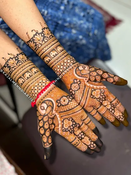 A sweet design for a baby shower, with Indian-style peacocks on the palms and a band of mini elephants on the wrists for good luck.