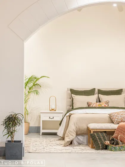 This view through an archway perfectly frames a bedroom setup, demonstrating how FA Home's products can be layered to create a serene and luxurious space. The use of plants adds a touch of natural freshness.