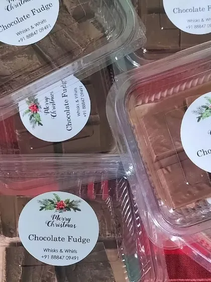 Close-up of our custom-printed 'Merry Christmas' labels on boxes of delicious chocolate fudge.