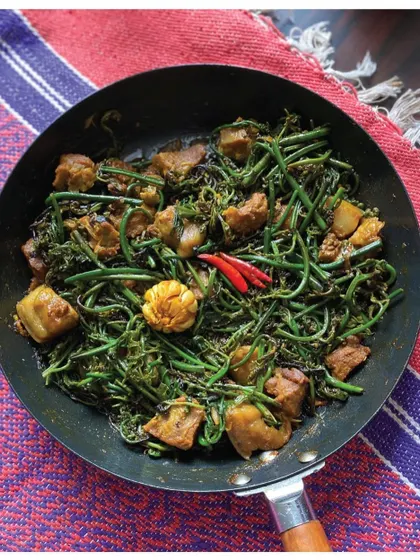 Fiddlehead Fern Pork from Assam, a tribal recipe that blends simplicity with rich, earthy flavors. The magic lies in the fatty pork releasing oils that blend beautifully with the ferns.