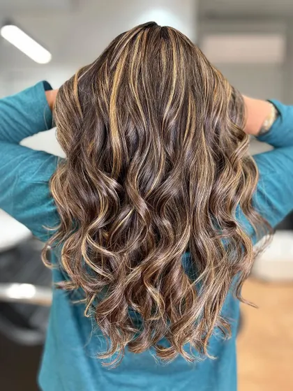 Honey blonde highlights that create a warm, sun-kissed effect. The color is bright and cheerful, perfect for any time of year.