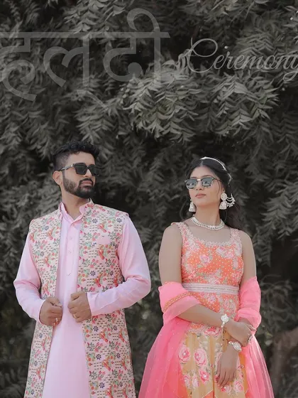 A cool and stylish portrait of the couple in their Haldi outfits. Their sunglasses and confident poses add a modern twist to the traditional ceremony.