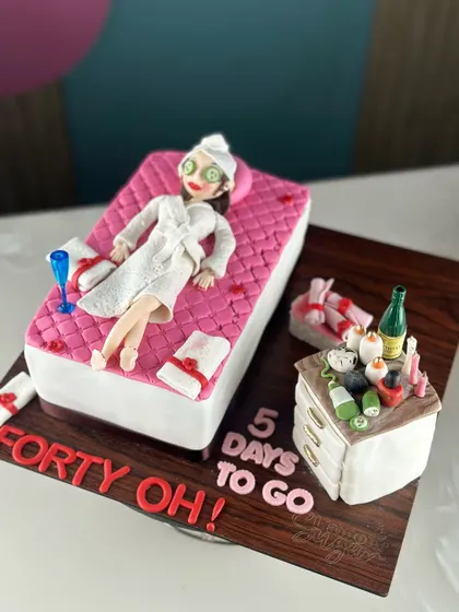Fabulous, fierce, and finally forty. This cake celebrates the big 4-0 in the most relaxing way possible, with a spa day theme complete with a fondant figure, cucumber eyes, and champagne.