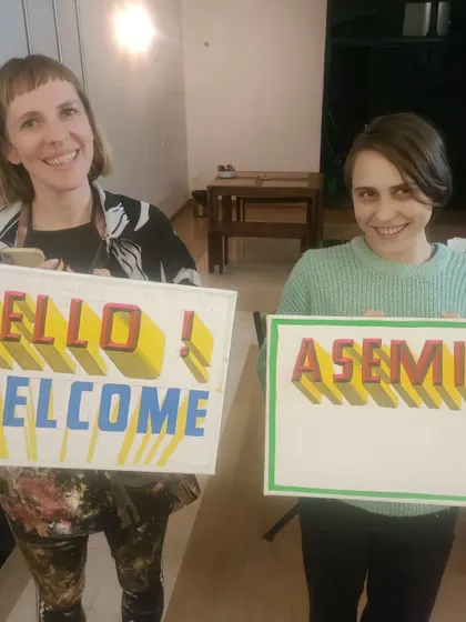 A closer look at the "Hello! Welcome" and "Asemic" signs, showing the clean, blocky 3D lettering style that is popular for modern decor.