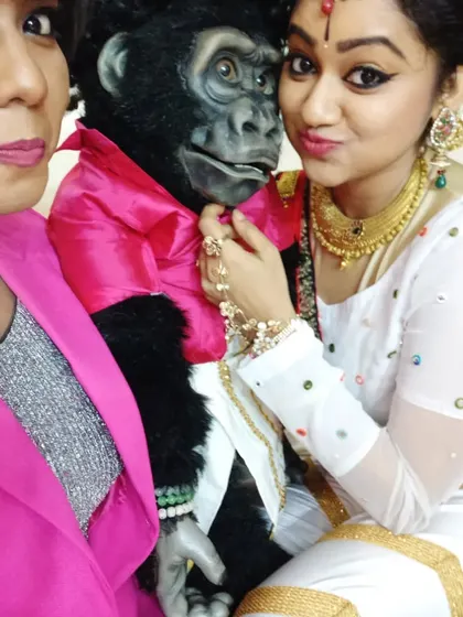 Nikki getting some love from a co-performer in her beautiful traditional dance attire. He is always the center of attention on set.
