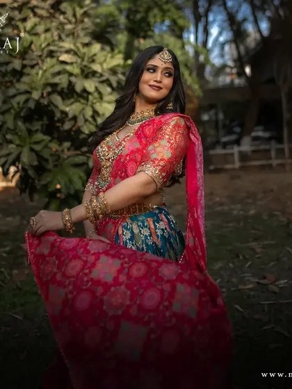 Unveil the allure of this beautiful multi-colored rusty orange & peacock blue banarasi lehenga, a perfect blend of tradition and contemporary elegance.