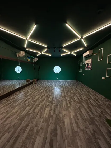 Welcome to Flex Studio. We designed this space as a clean, creative canvas with professional green walls, custom lighting, and a full-length mirror for you to bring your vision to life.