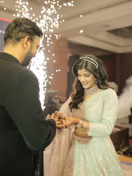 The moment he slips the ring on her finger, surrounded by sparks. This is the climax of the engagement ceremony, a magical start to their forever.