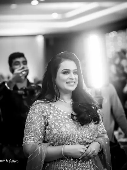 A joyful black and white portrait of the bride-to-be at her engagement. The bright backlighting creates a beautiful halo effect, highlighting her happiness.