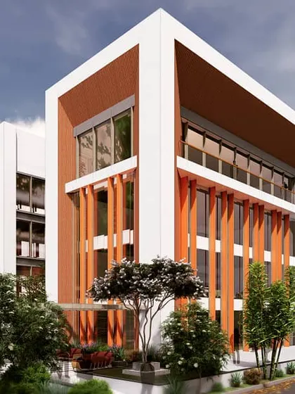 This corner view of the BGS school proposal emphasizes the building's clean lines and strong geometric form. The interplay between solid white frames and warm-toned vertical elements gives the large structure a sense of balance and visual interest.