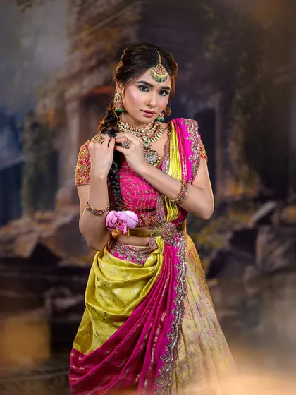A model in a vibrant pink and yellow lehenga, perfect for a pre-wedding celebration. The look is fresh, colorful, and youthful.