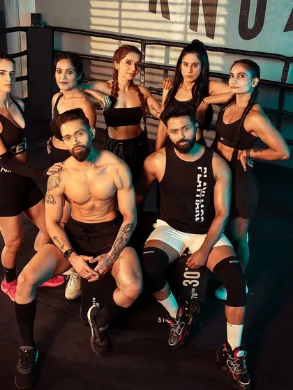 A group shot of me, my partner, and my female clients at the photoshoot, showcasing the strong, supportive community we've built.
