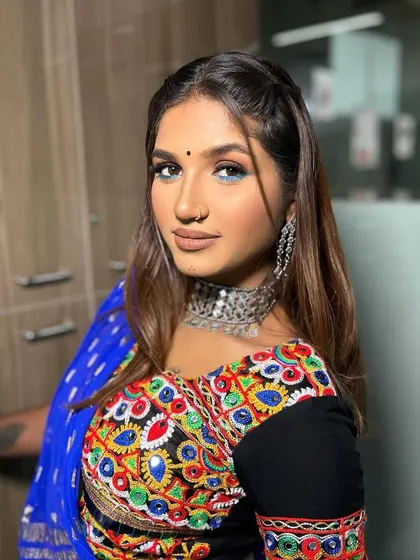 Rocking the perfect Navratri look. This style features a pop of blue on the lower lash line to match the outfit, paired with a bold winged liner and traditional jewellery.