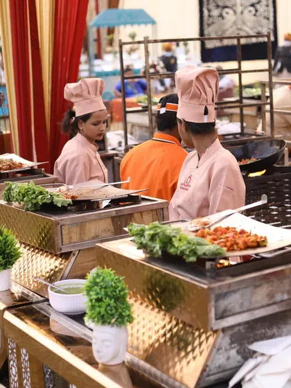 My live grill stations are perfect for adding sizzle to any event. Here, my female chefs in pink uniforms prepare delicious grilled appetizers, offering guests a fresh and interactive dining experience.