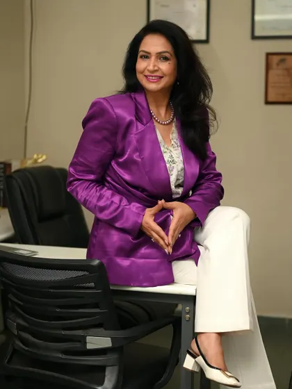 A modern and powerful pose, with the client perched on her desk. This unconventional shot breaks from tradition and shows confidence and a bold personality.