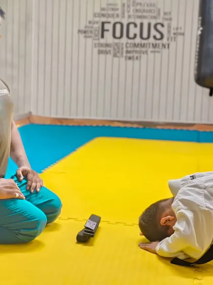 The traditional bow after receiving a new belt, a sign of humility and respect for the art and the teacher.