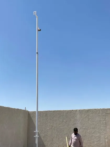 A long-range surveillance setup using a camera mounted on a tall pole. This is ideal for covering very large open areas like farms or construction sites.