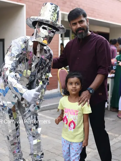 Creating memories for the whole family. Our Silver Mirror Man happily poses for a photo with a father and his daughter.