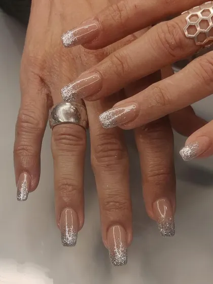A full set of long, clear square extensions with a sparkling silver glitter fade from the tip.