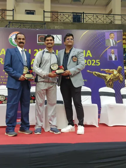 Receiving an award alongside other officials at the Bengaluru Open Karate Championship. It is an honor to be recognized by my peers in the karate community.