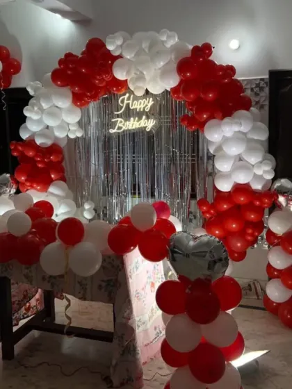 Another view of the red and white home setup, showing how it frames the cake table. I can arrange the decoration to fit your specific space and furniture layout.