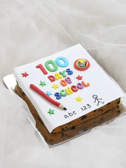 Celebrating a wonderful school milestone with this "100 Days of School" cake. The cake is designed to look like a notebook page, complete with colorful letters, a fondant pencil, and fun doodles.