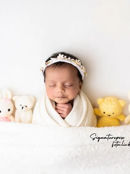 A duplicate of image 59, a sweet and simple portrait with stuffed animal friends.