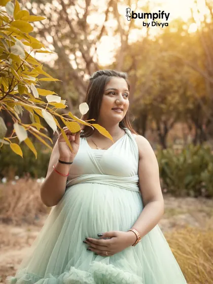 A close-up portrait capturing the soft light and the gentle expression of the mom-to-be. The golden hour glow makes these outdoor maternity photos extra special.