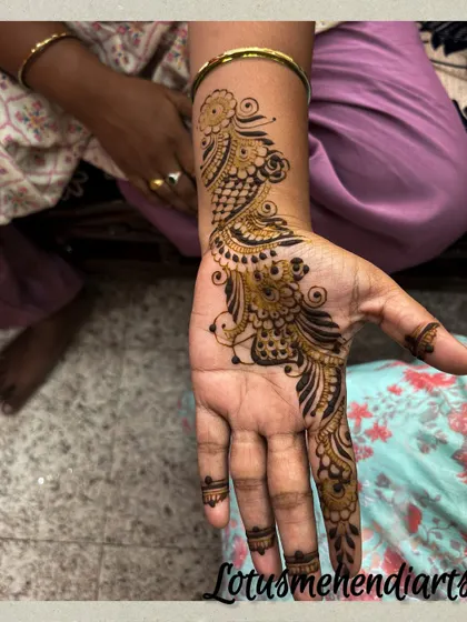 A single, graceful peacock motif design for a guest. This style is perfect for someone who wants a touch of traditional art that is both quick and beautiful.